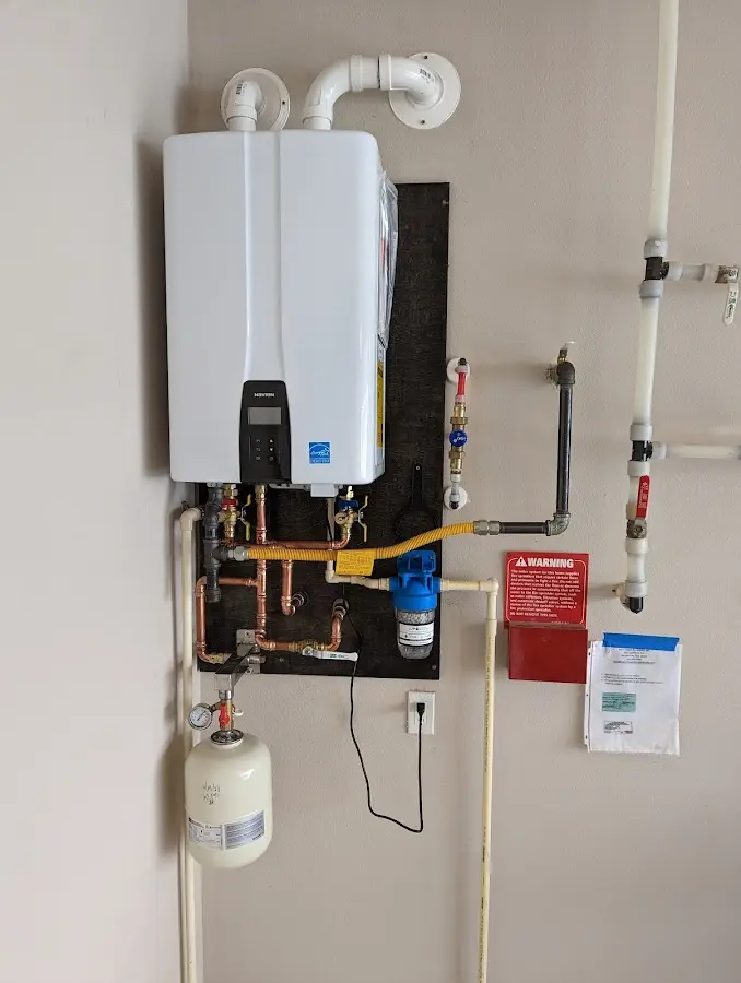 Professional plumber installing copper piping in a Berryville home
